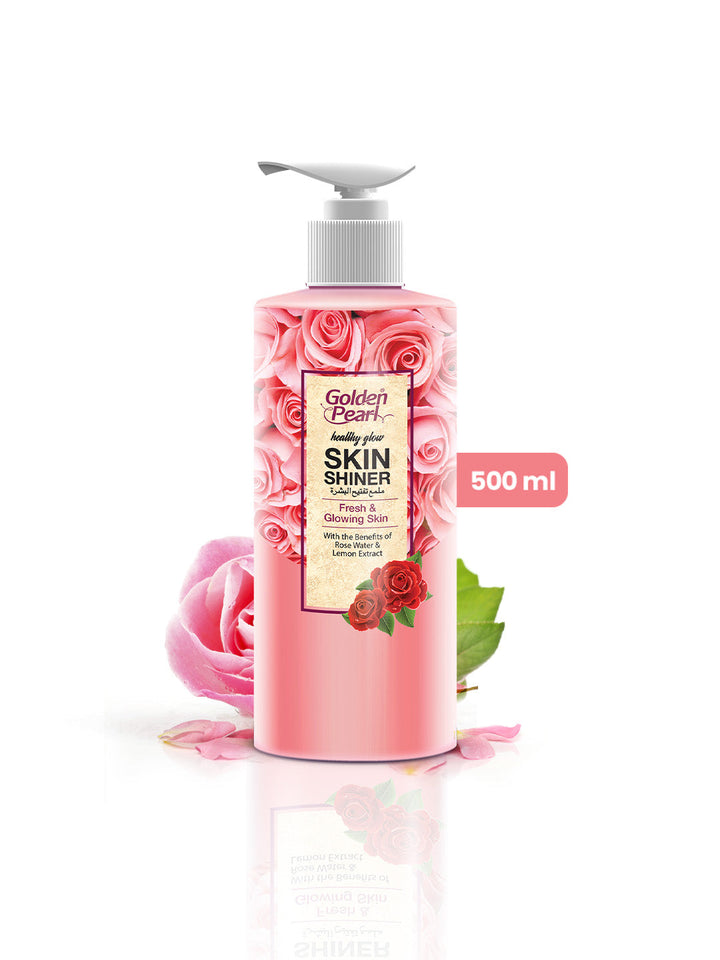 Pink bottle of Golden Pearl Skin Shiner with roses and leaves on a white background