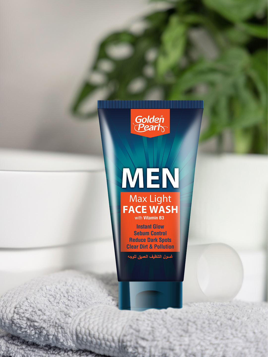 Tube of Golden Pearl Men Max Light Face Wash on a towel with a blurred plant background