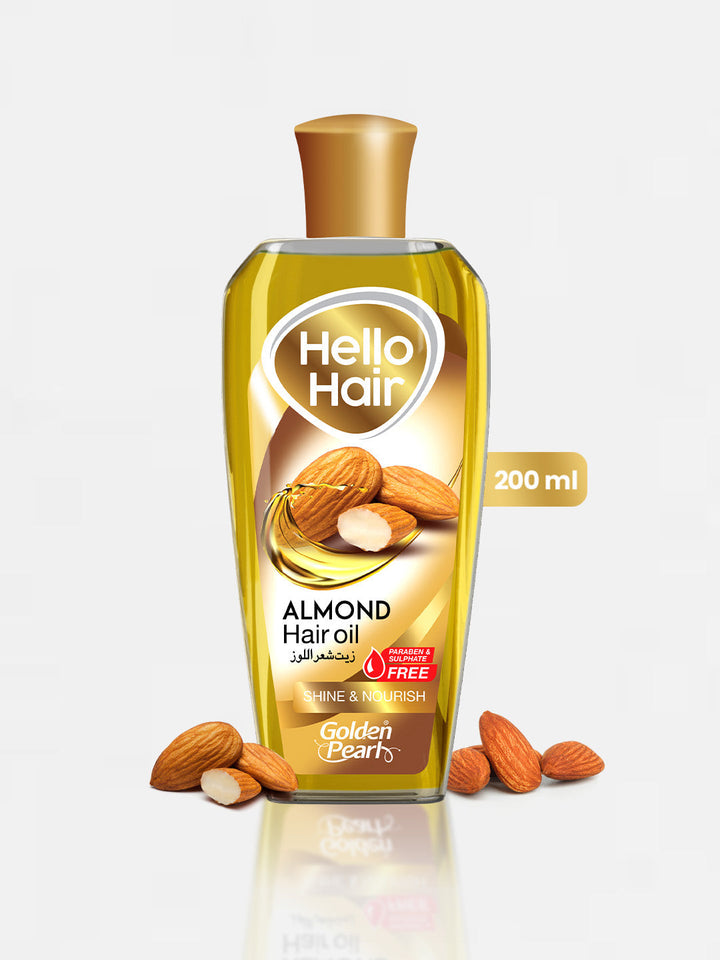 Bottle of Hello Hair Almond Hair Oil with almonds on a white background