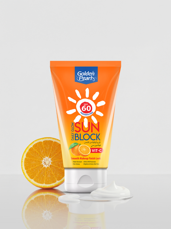 Sunblock tube with an orange next to it on a light gray background